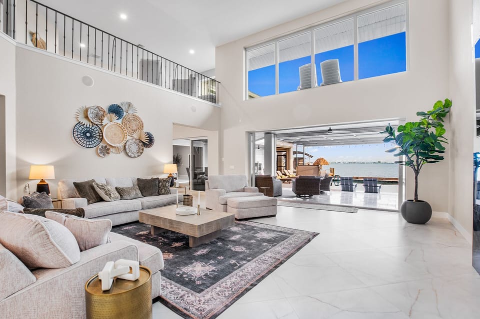Living Room: Bright, airy space with stunning water views