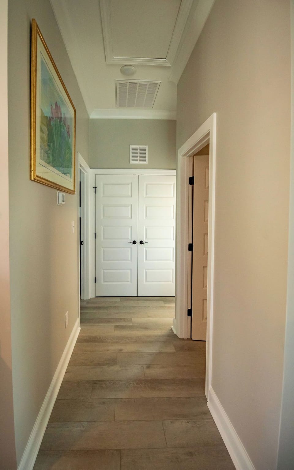 Washer & dryer located behind the double doors conveniently outside the primary & guest bedrooms. 