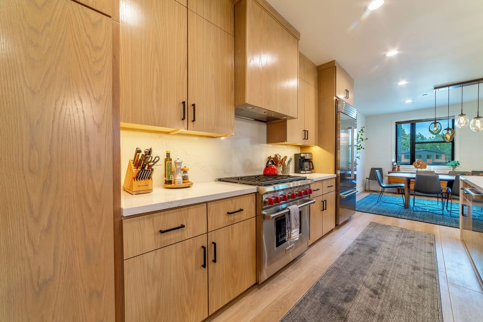 Chef's kitchen has gorgeous white oak cabinets, solid quartz countertops, and high end appliances.