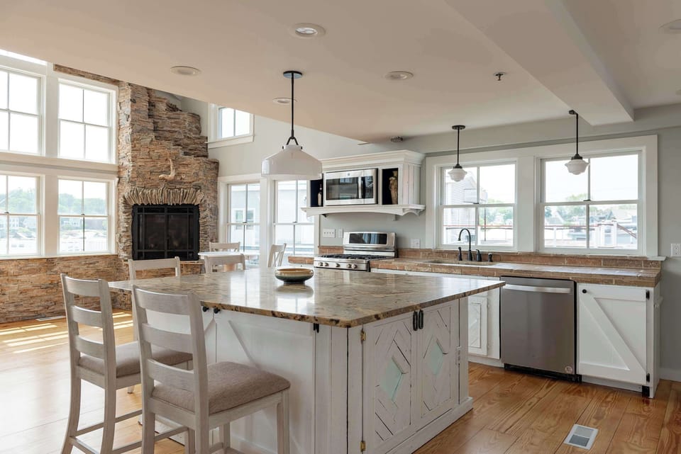 Chef's kitchen with island seating and stainless appliances