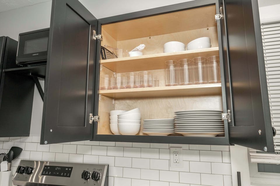The sleek, open kitchen offers ample space & every home comfort
