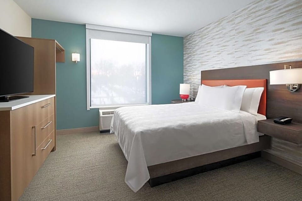 Drift off in a calm, sunlit room with plush bedding.