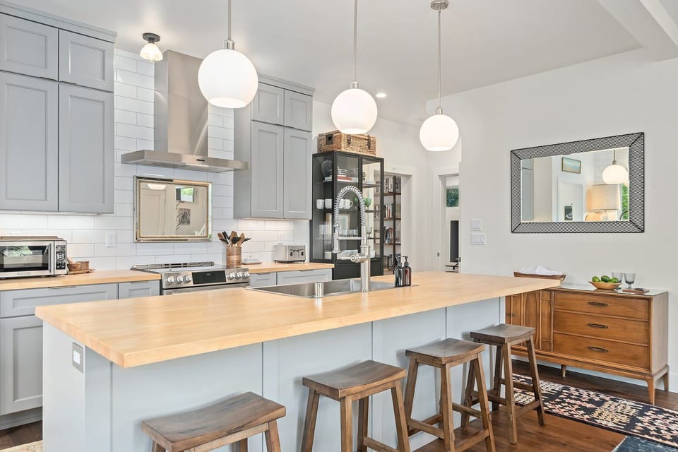 Sleek, spacious kitchen with a butcher-block island and bar seating for easy entertaining.