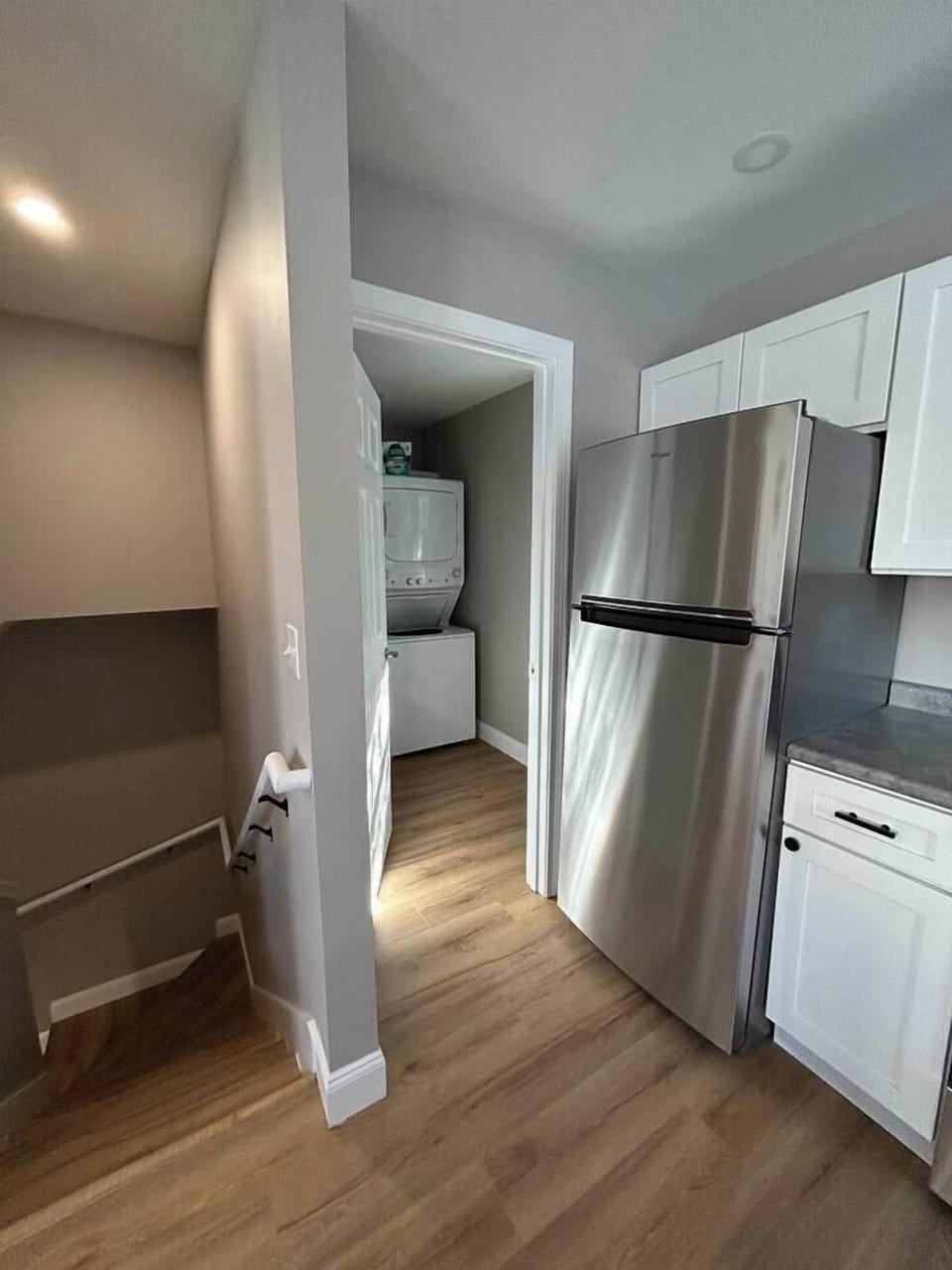 Kitchen looking to the laundry room and stairs down to the two bedrooms.