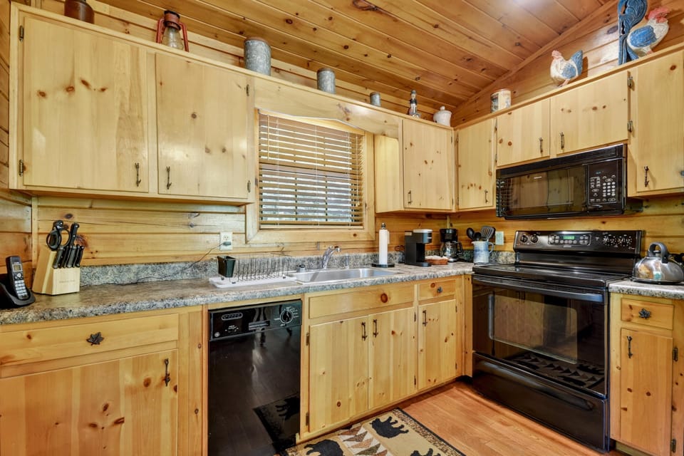 Rustic kitchen with wooden cabinetry and modern appliances, ideal for cooking.