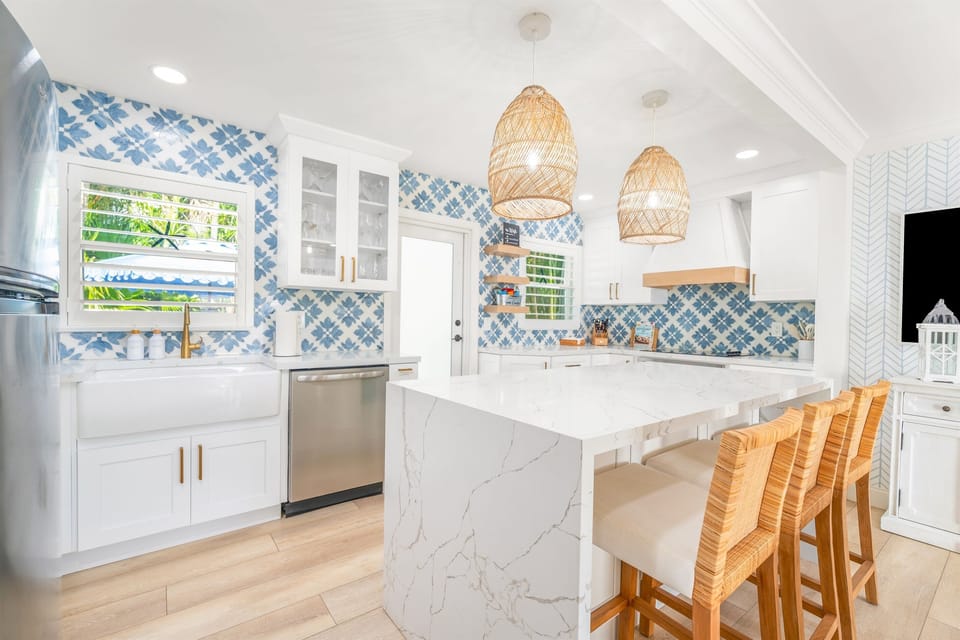 Stunning custom tilework and a deep farmhouse sink make prep work a breeze.