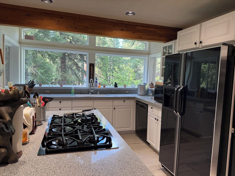 Gas stove top, double oven, large refrigerator and TV as well