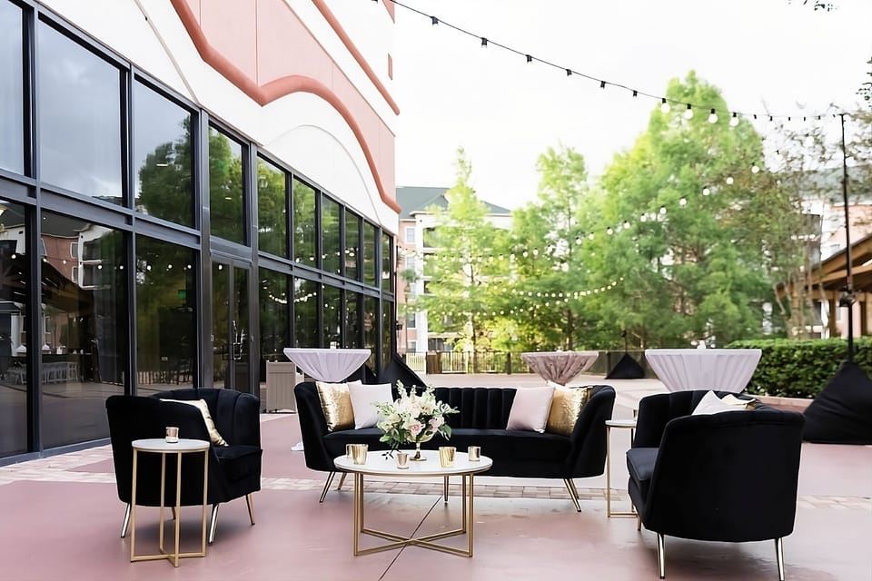 Relax outdoors with chic seating under twinkling string lights.