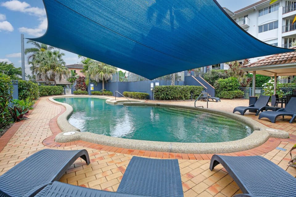Relax and unwind in the sparkling shared swimming pool, surrounded by lush tropical landscaping. Perfect for cooling off after exploring Cairns, the pool area offers comfortable seating and a peaceful atmosphere.