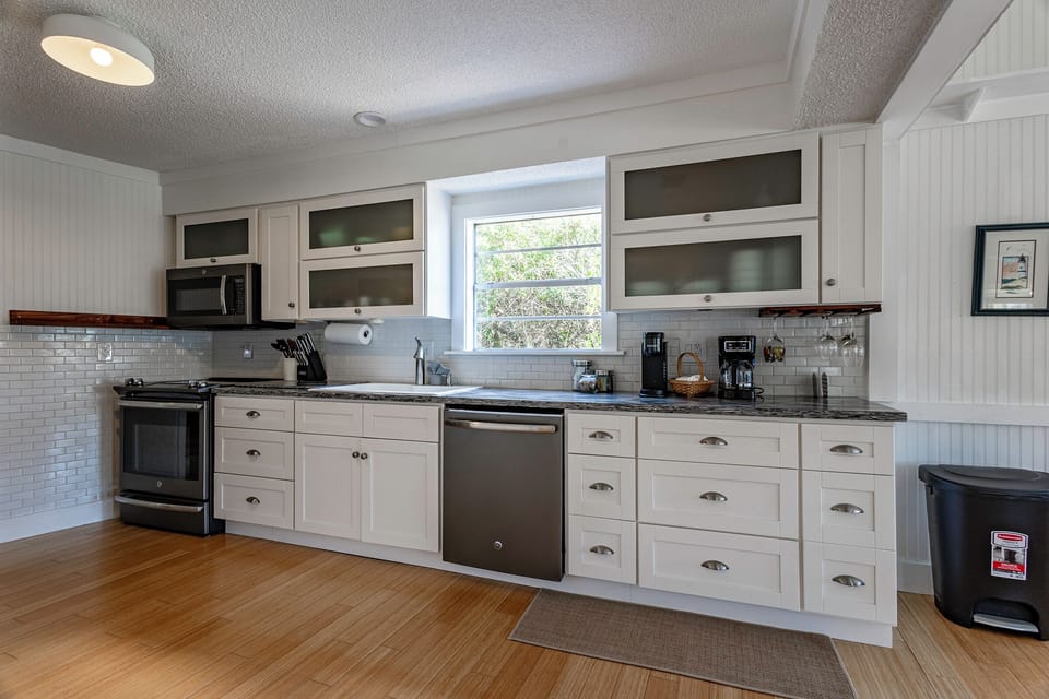 kitchen includes a full-size fridge, stove/oven, microwave, dishwasher and both Keurig and regular coffee makers—we keep it stocked with the basics, plus some coffee and sugar to get you started