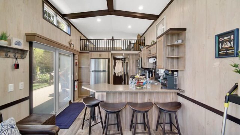 Kitchen with a sliding glass door, connecting the interior space to the tranquil lake setting just outside.