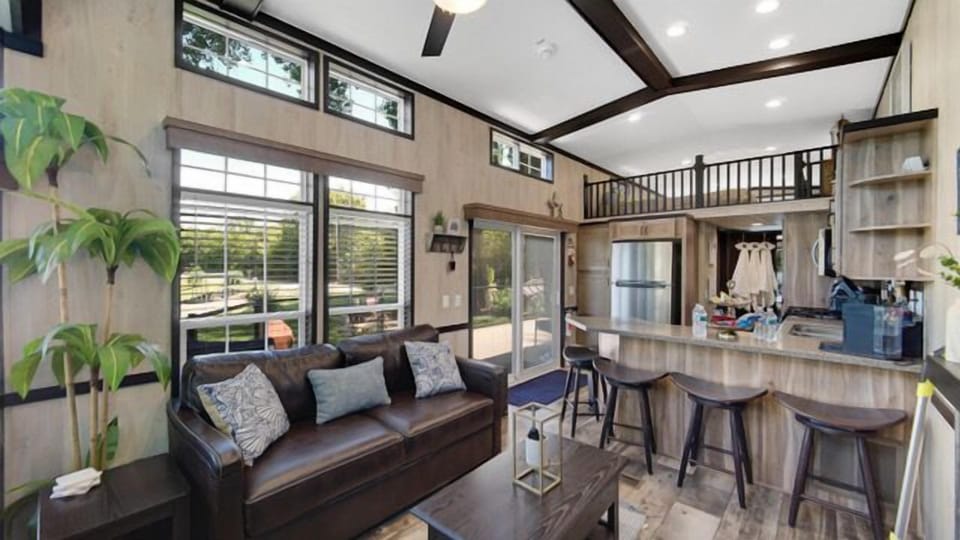 Living area with a couch and built-in bed, perfect for extra guests or lounging.