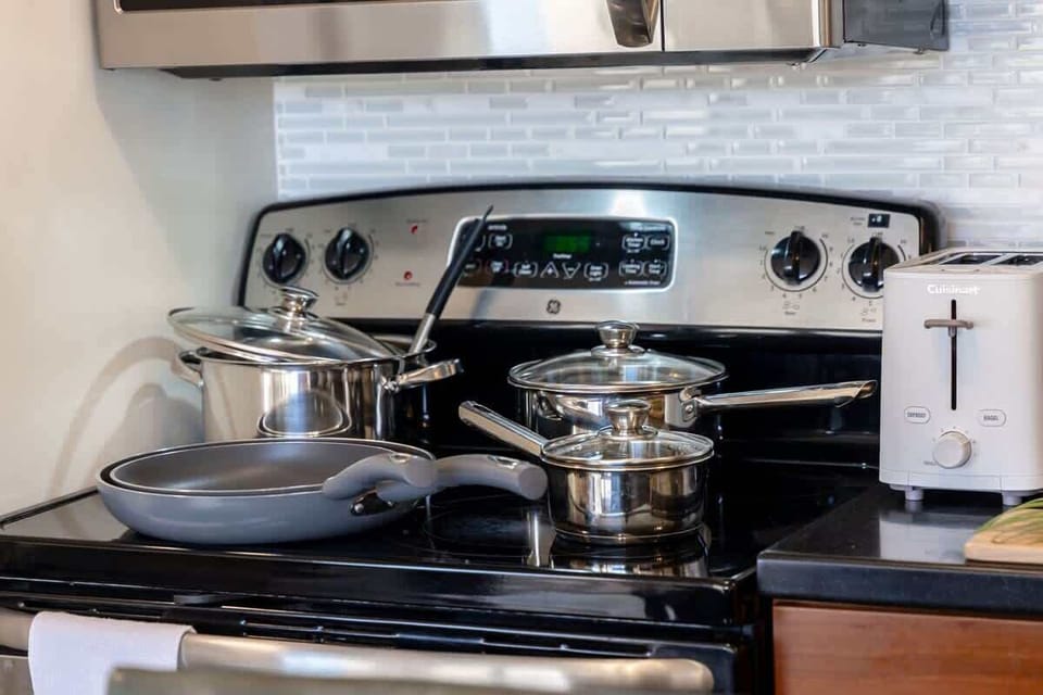 Prepare delicious meals with ease using the fully equipped GE electric range, complete with a variety of pots and pans for your culinary needs
