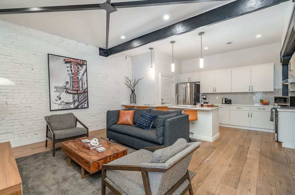 Open-concept living area featuring cozy furnishings, smart TV, and a sleeper sofa.