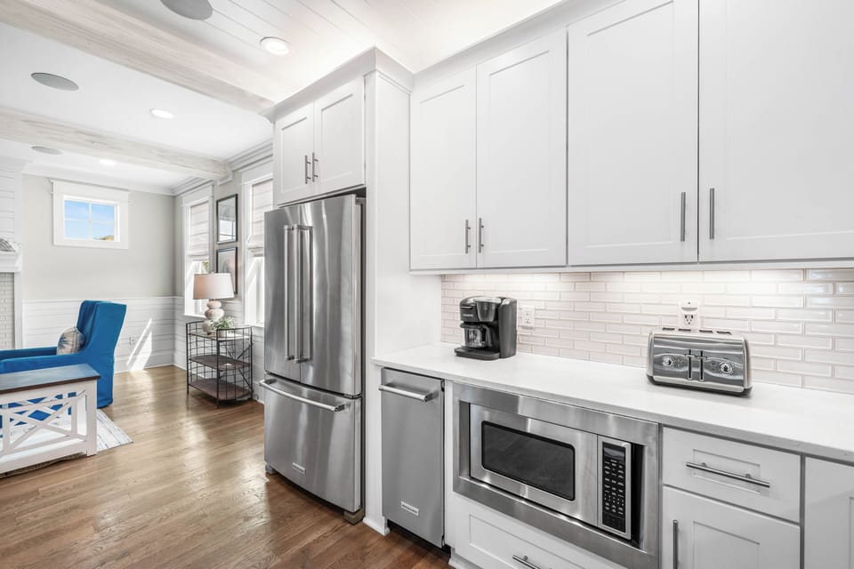 This sleek kitchen station makes morning coffee a breeze, featuring a built-in microwave, toaster, and a refrigerator