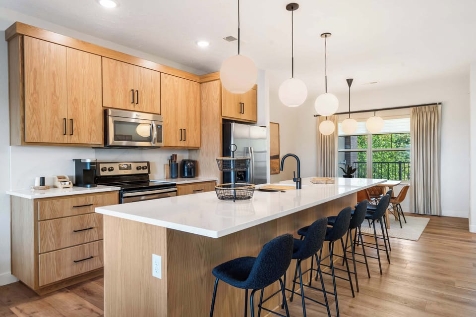 The chic, open kitchen offers ample space & every home comfort