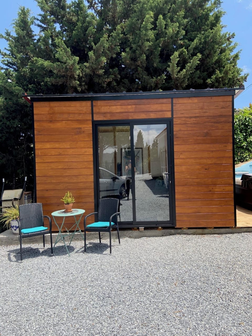 wooden casita , includes kitchenette, fridge, lounge area and dining area.