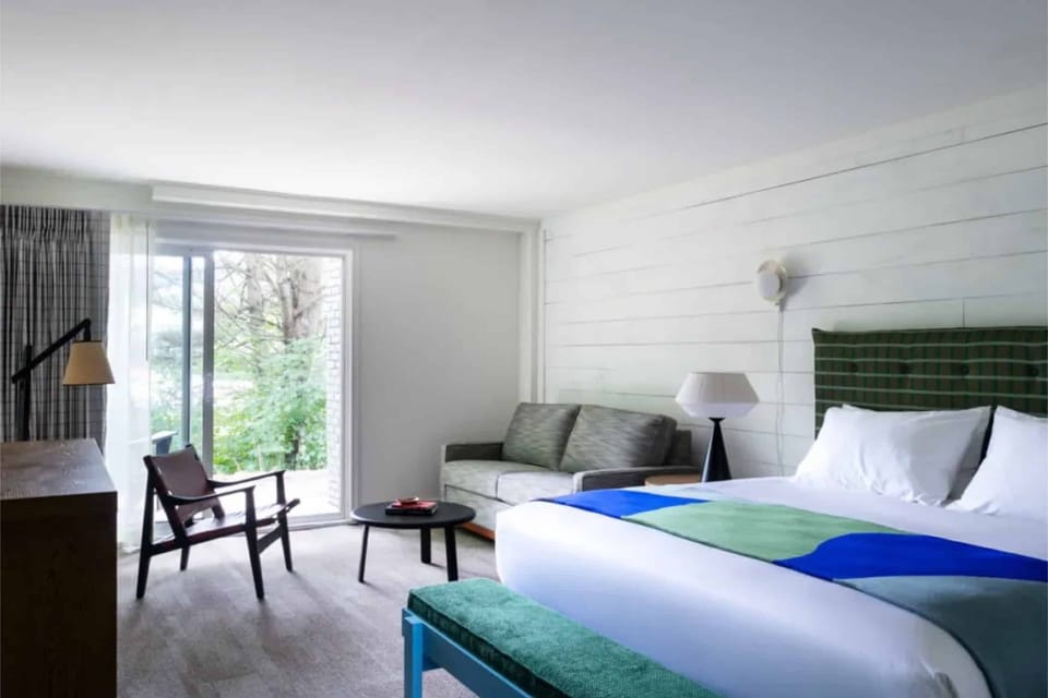 Wake up to soft daylight and garden views by the bed.