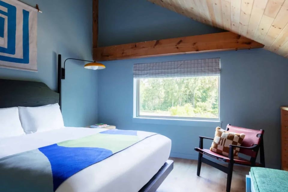 Unwind in a serene bedroom with bright linens and views.