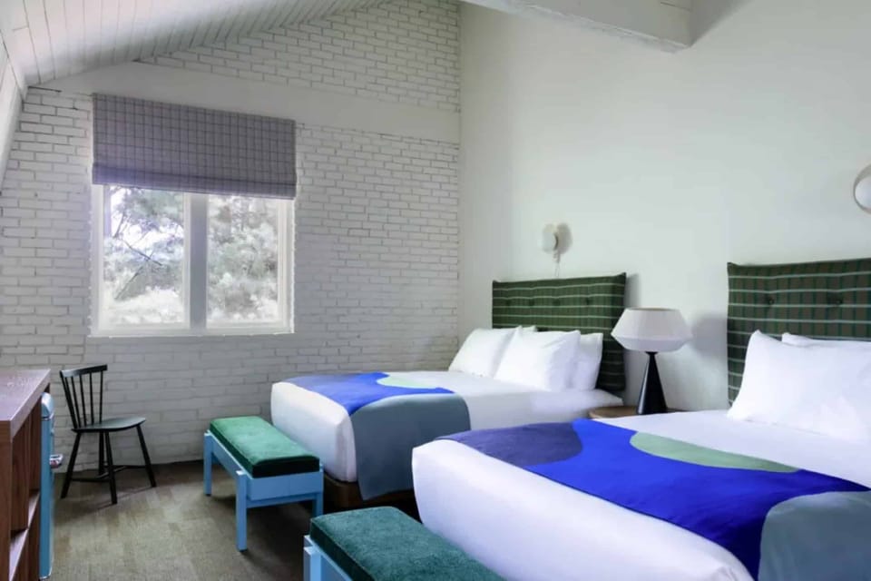 Unwind in crisp beds with soft textiles and calm light.