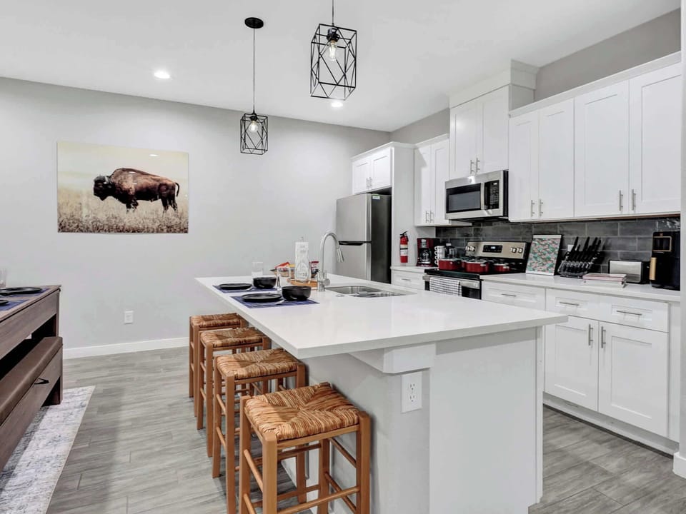 Modern Kitchen: Sleek design with stylish bar seating, perfect for culinary adventures!