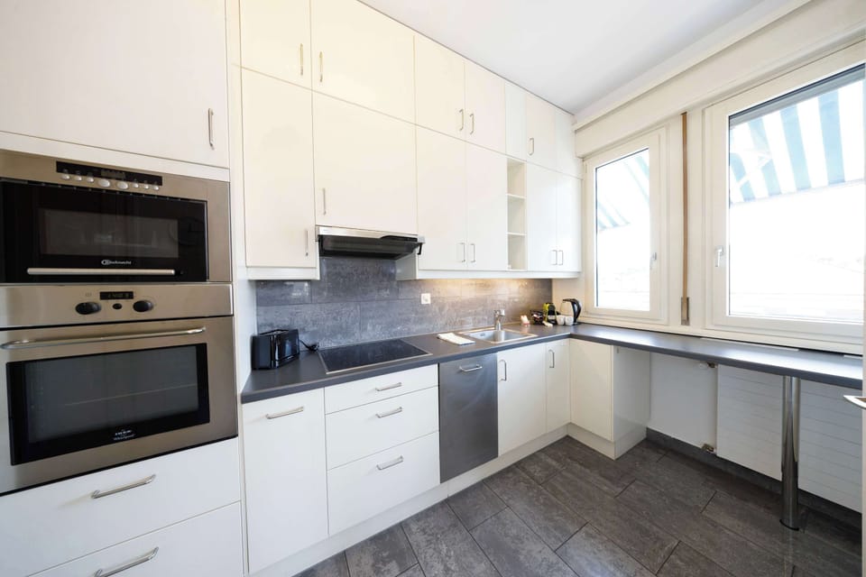 Fully equipped kitchen that displays a sophisticated design style  