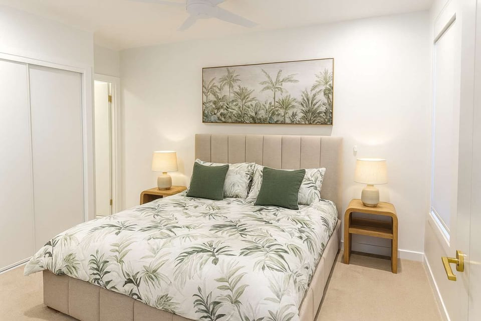 Studio apartment bedroom with queen bed and fresh linen