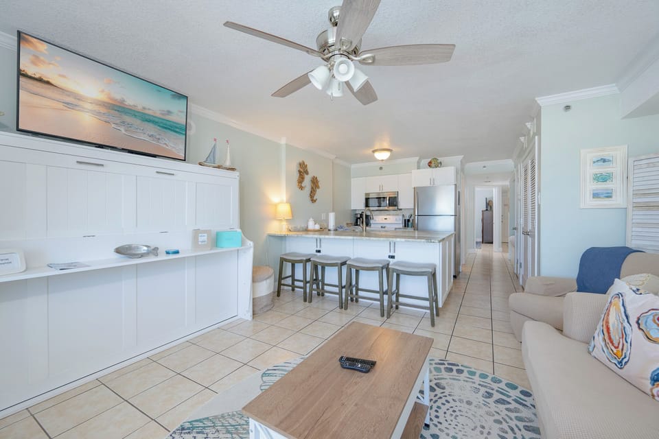 Living area featuring cozy seating, queen sofa-sleeper, and charming coastal decor for a relaxing getaway