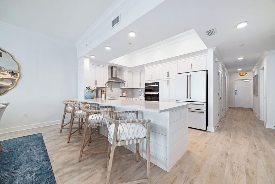 Gather around this upgraded modern kitchen with a sleek design and elegant lighting for morning coffee