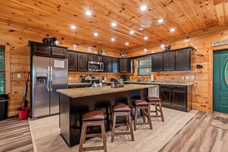 With plenty of counter space, bar seating for four, and open views into the cabin, this kitchen makes it easy to stay connected while you cook.