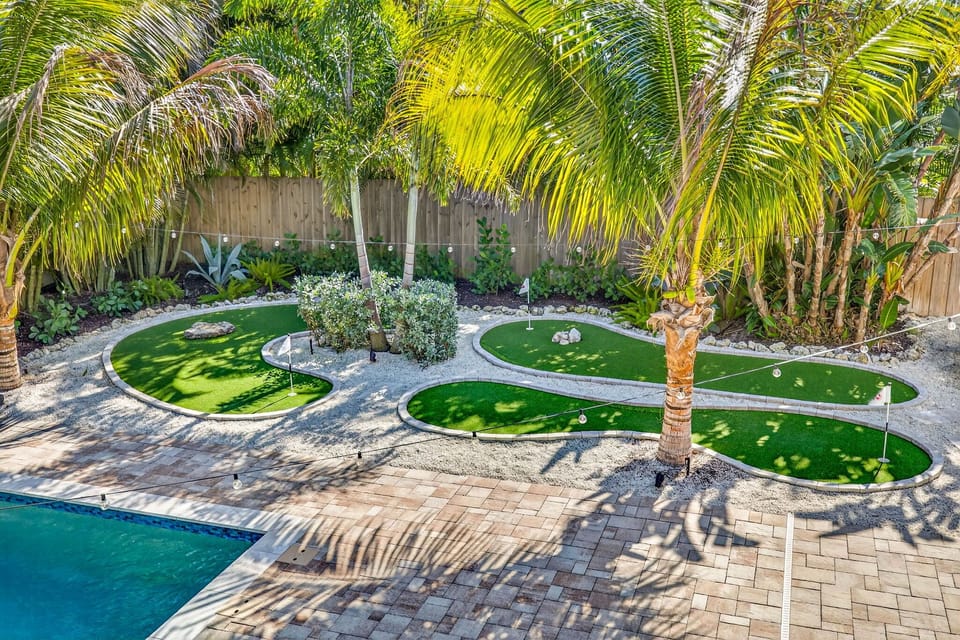 3 hole putt putt course surrounded by mature, tropical landscaping.