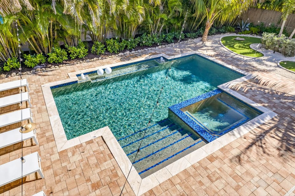 Backyard view from the covered porch off the kitchen--pool & sp, golf, loungers.