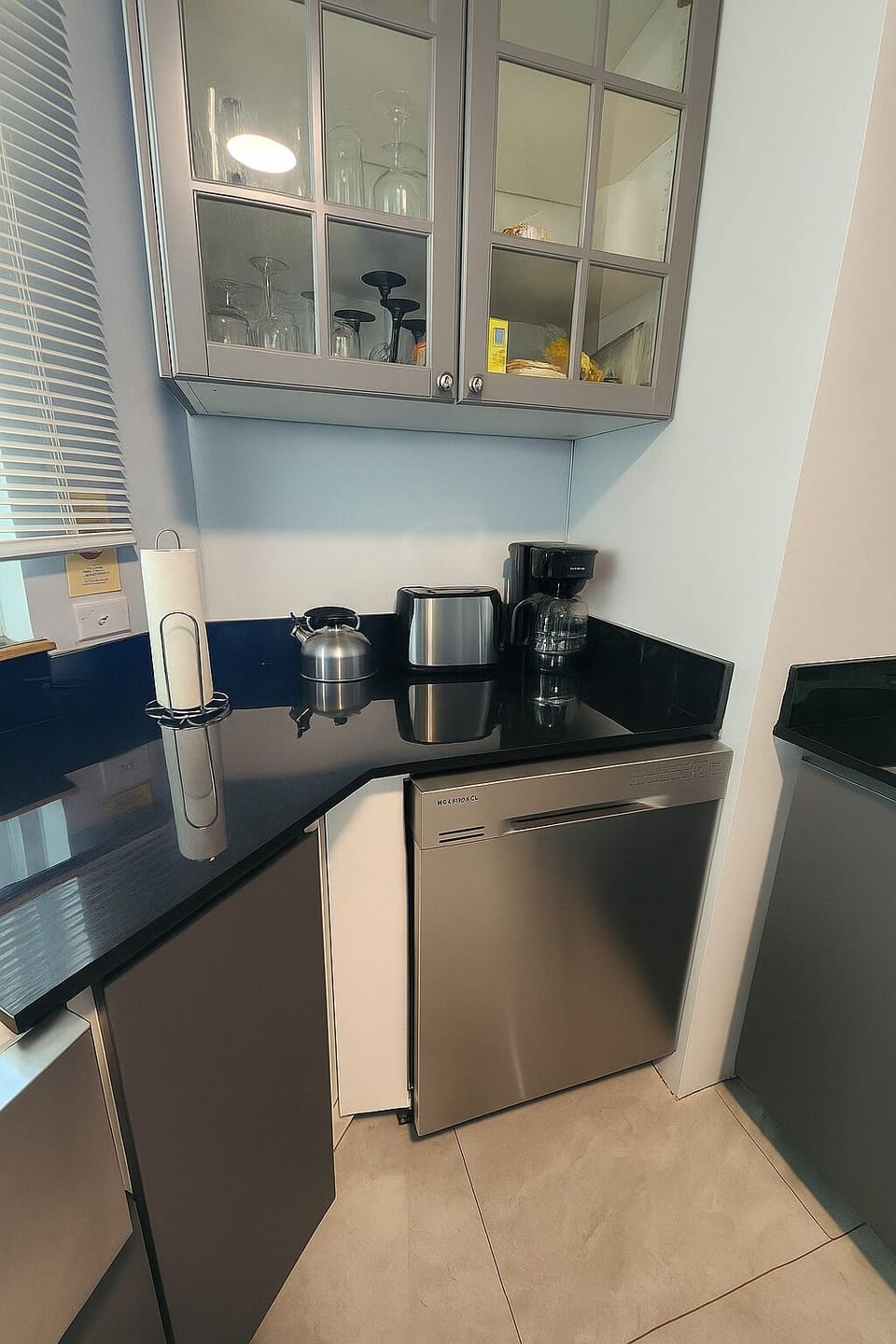The kitchen is equipped with a toaster, kettle, and coffee maker