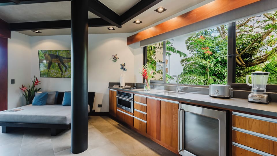 Kitchen with convection/microwave oven, mini fridge, ice maker, cooktop, and more