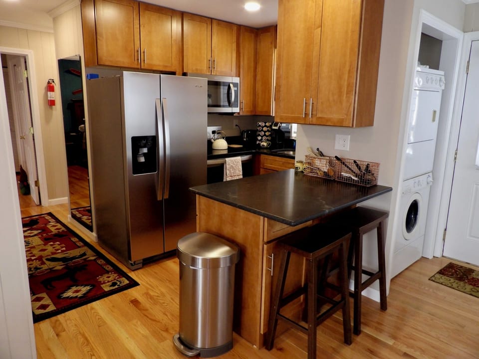 The newly renovated kitchen with new appliances, cabinets, and granite counters