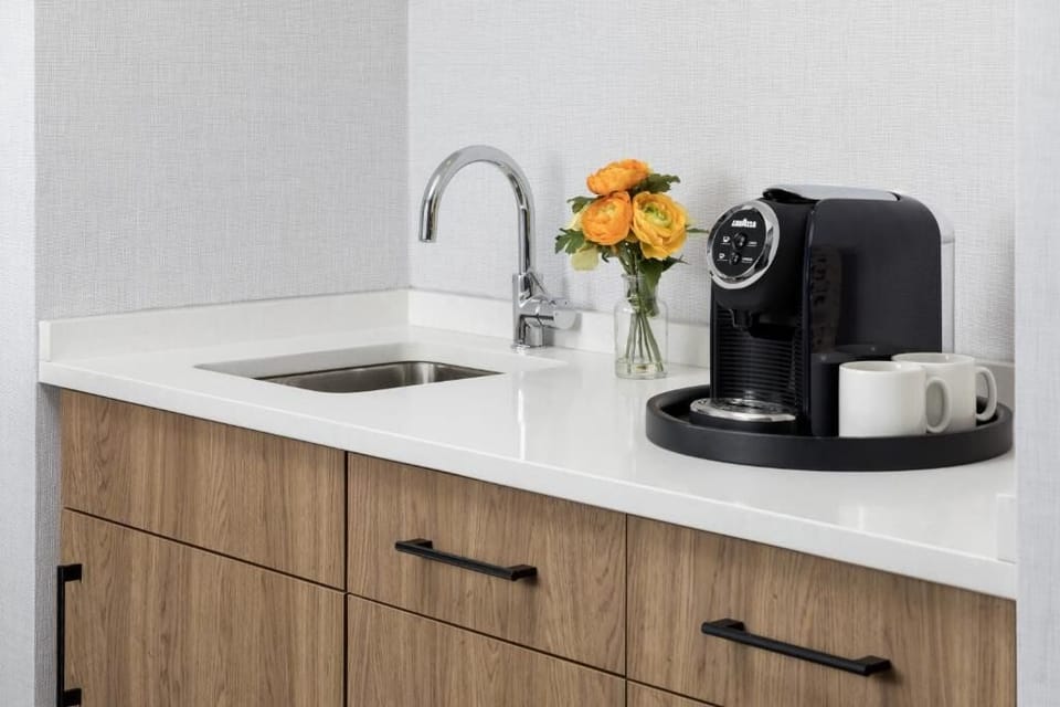 Start mornings right with sleek kitchenette coffee and sink.