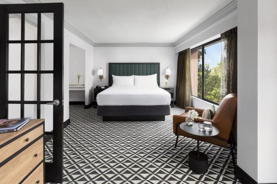 Settle into crisp linens with a cozy reading corner nearby.