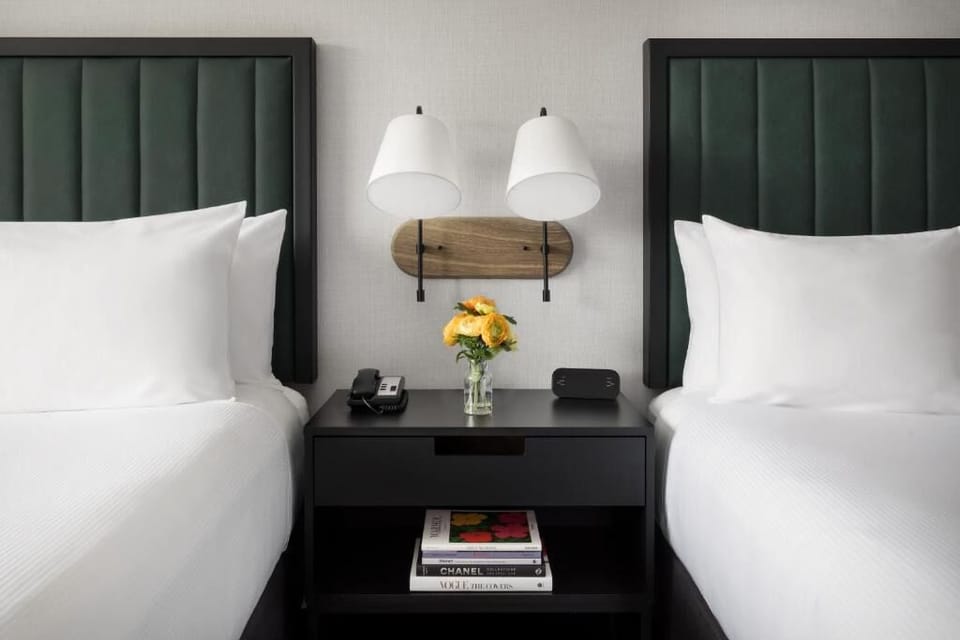 Recharge beside stylish headboards, warm lamps, and fresh flowers.