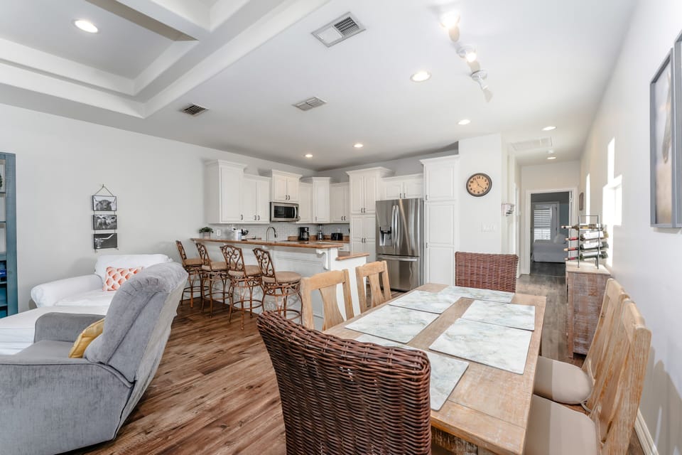 Bright open layout connecting the living room, dining area, and kitchen, ideal for family gatherings and group entertaining.