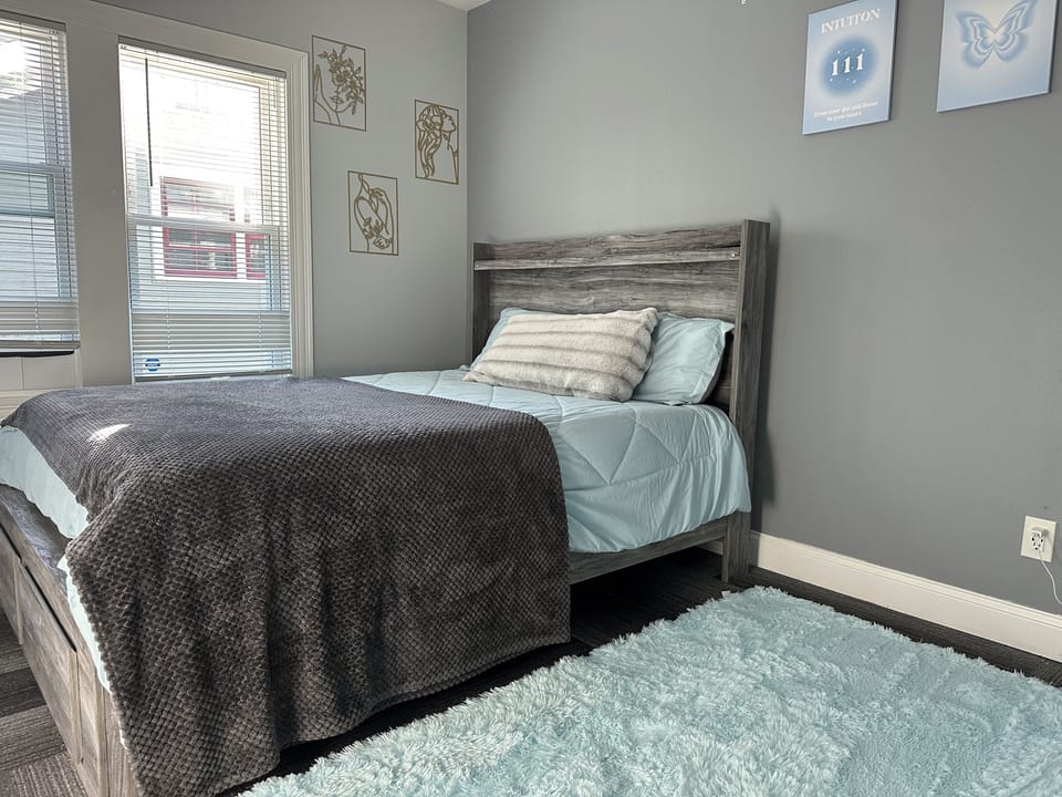 Plush queen bed, 55” Smart TV, cozy vibe, soft lighting—your perfect private room retreat!