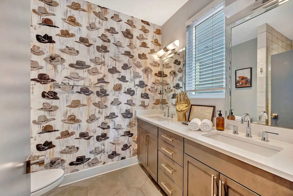 A double vanity and Western touches make this full bathroom functional for groups; everyone gets their own sink and their own Nashville moment