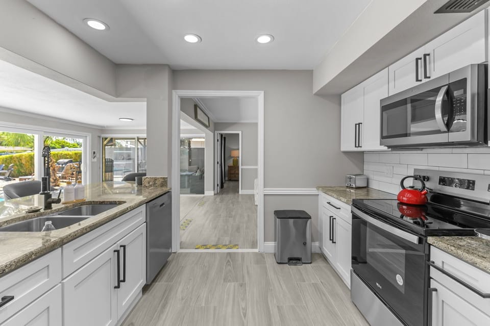 Features high seating at the island, offering the perfect spot to socialize while cooking and easily transition to the outdoor space for dining or relaxation.