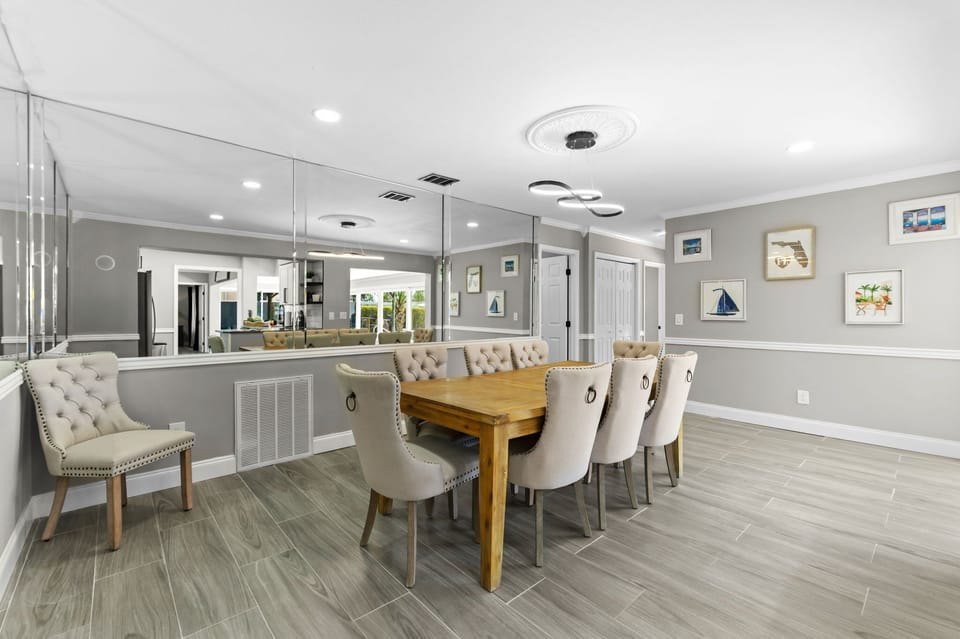 Sit back and enjoy your meal in a dining area that seats 8-10, enhanced by mirrors that reflect the warmth of your gathering and the beauty of the space.
