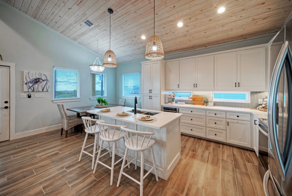 Fully equipped kitchen with barstool seating.
