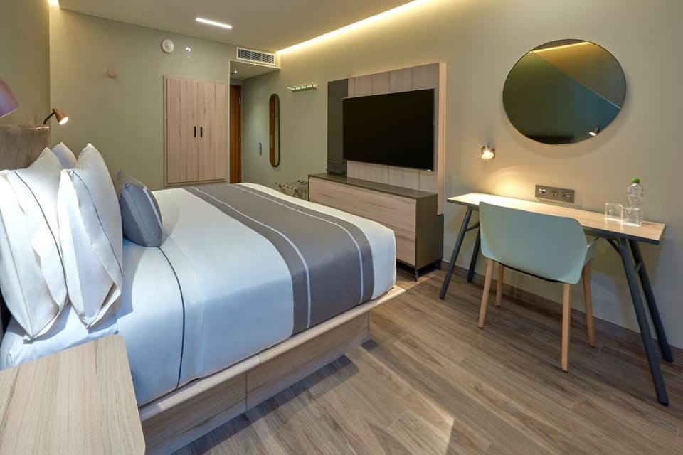 Settle in with a spacious work desk and big-screen TV.
