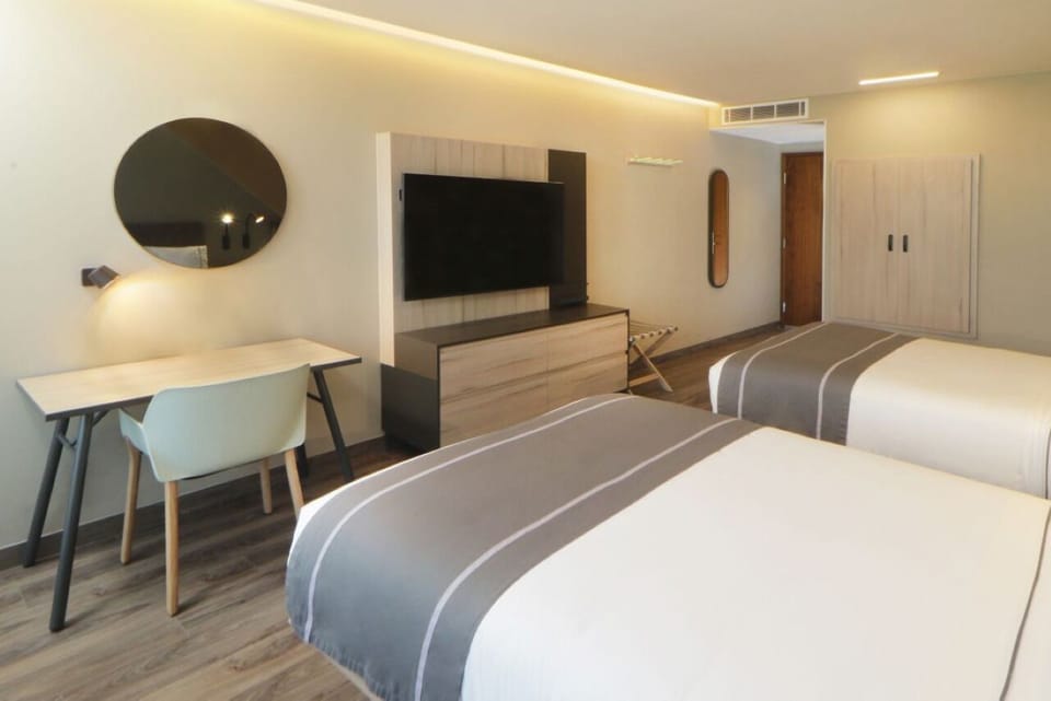 Recharge in a calm, modern room designed for deep rest.