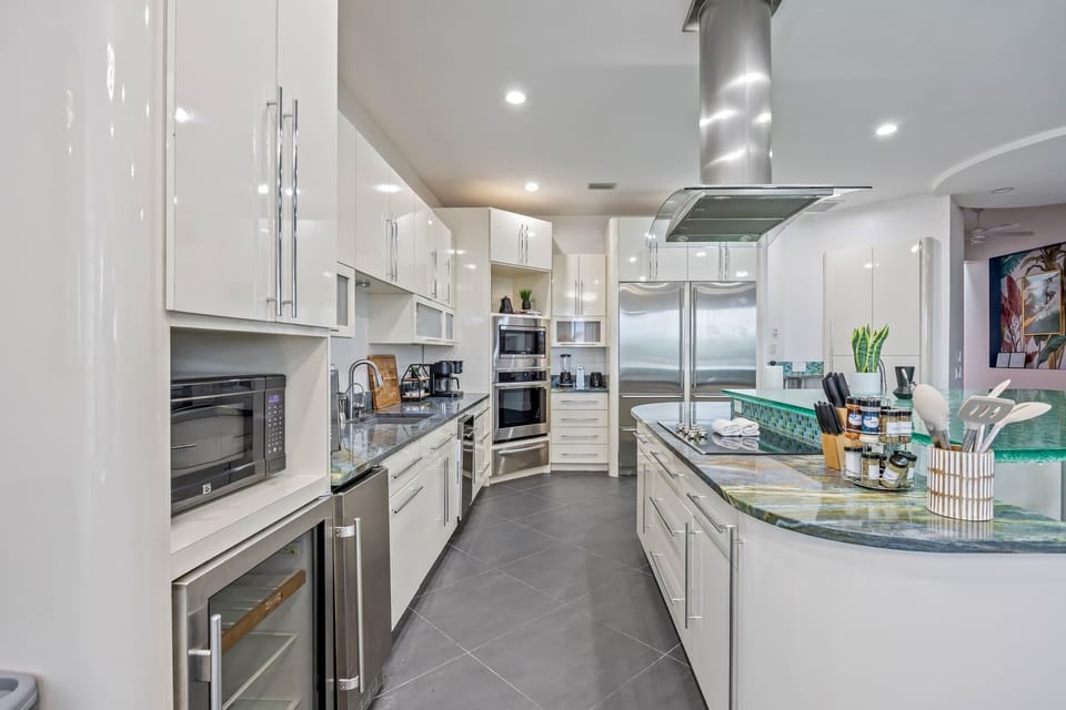 Modern kitchen with stainless steel appliances and a spacious island for cooking and entertaining.