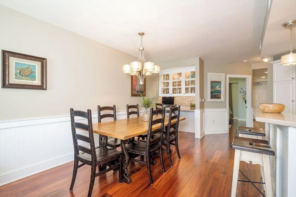 Dining table for 6 and breakfast bar flow seamlessly into the open concept living area