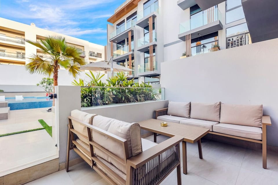 Outdoor Lounge: Relax in style with lush views and a refreshing pool nearby! Perfect for sun-seekers!