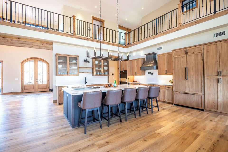 Chef's kitchen with premium appliances, granite counters, and large island.